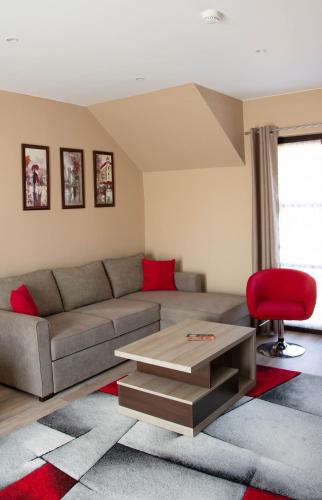 a living room with a couch and a table at MeDoRa Park - Hotel MeDoRa*** in Gárdony