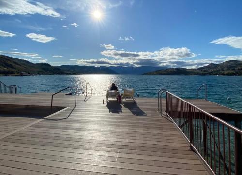 a person sitting on a boat on a dock at Lake Chelan Executive Condo in Chelan