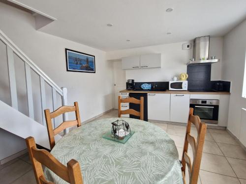 une cuisine et une salle à manger avec une table et des chaises dans l'établissement Cottage in Brittany near Monts d'Arrée, à Guerlesquin