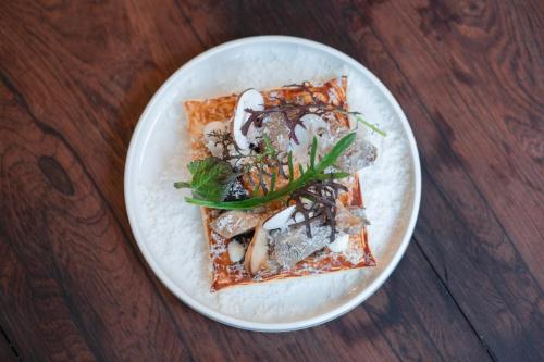 a white plate of food on a wooden table at The Coach House in Roundwood