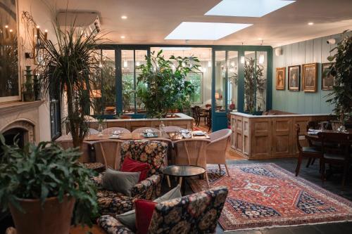 a restaurant with tables and chairs and a fireplace at The Coach House in Roundwood