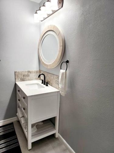 a bathroom with a sink and a mirror at blue door house grand studio in Lakeland