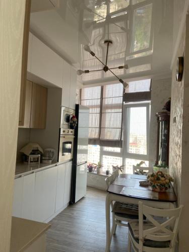 a kitchen with a table and a dining room at Панорама-Батуми in Batumi