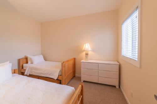 a bedroom with two beds and a window at The Hermitage at Napeague in Amagansett