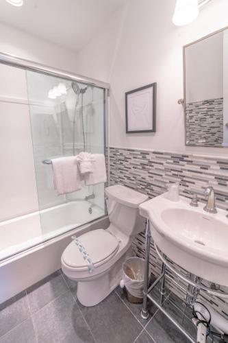 a bathroom with a toilet and a sink at The Hermitage at Napeague in Amagansett
