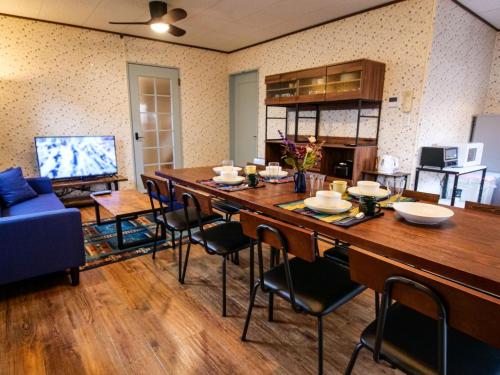 a dining room with a large wooden table and chairs at Villa228KASAMA - Vacation STAY 92175v in Kasama