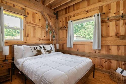 a bedroom with a bed in a wooden room at The Rustic Retreat in Pearl City