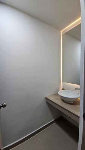 a bathroom with a white sink and a mirror at Estadía Familiar in Ibagué