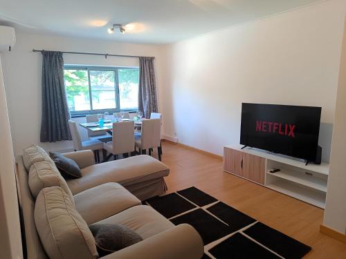 a living room with a couch and a television at Ponta Delgada 3 Bedroom Apartment in Ponta Delgada