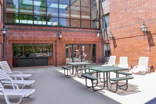 a group of tables and chairs in front of a brick building at Park Plaza Resort - Park City, Ascend Collection Hotel in Park City