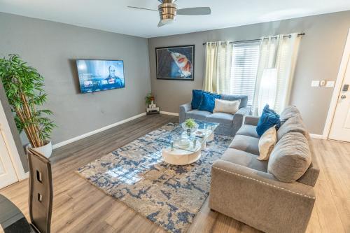 a living room with a couch and a table at Spacious 2-Bedroom Townhouse with Pool & Private Patio in Central Las Vegas in Las Vegas