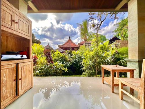 a patio with a view of a garden at The Madawa Suites in Ubud