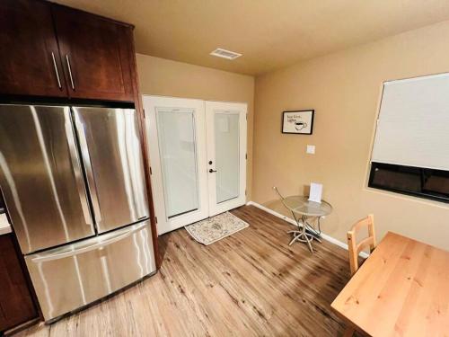 a kitchen with a stainless steel refrigerator and a table at The Bluejay Cabin at Munds Park, AZ! in Sedona