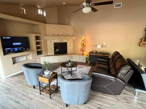 a living room with a couch and chairs and a fireplace at The Bluejay Cabin at Munds Park, AZ! in Sedona