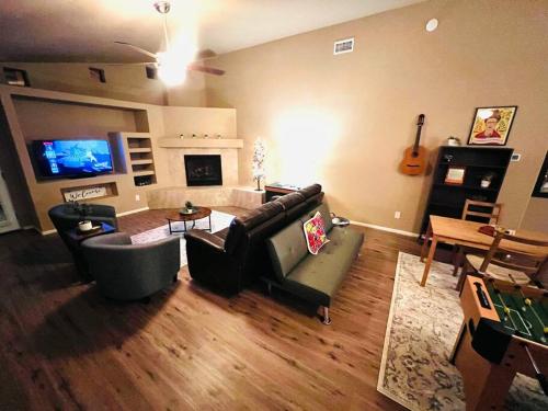 a living room with a couch and a table and a tv at The Bluejay Cabin at Munds Park, AZ! in Sedona