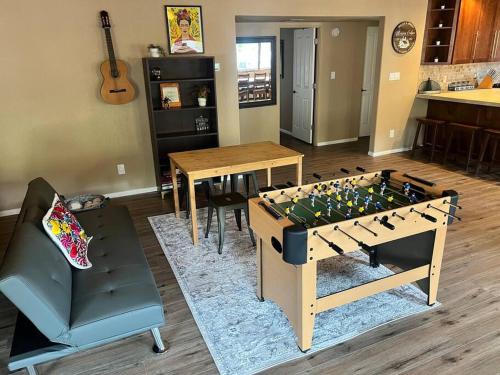a living room with a foosball table in the middle at The Bluejay Cabin at Munds Park, AZ! in Sedona