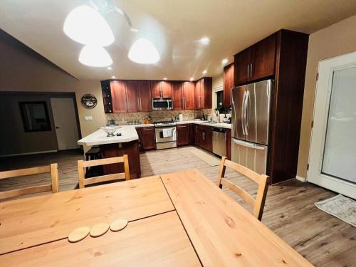 a kitchen with a wooden table with chairs and a dining room at The Bluejay Cabin at Munds Park, AZ! in Sedona