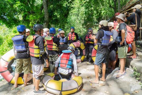 a group of people in rafts on a river at Aranka Tempasan in Sangyang
