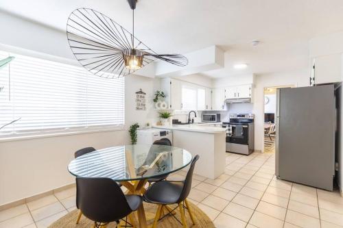 a kitchen and dining room with a glass table and chairs at Beautiful Vancouver Special Home in Vancouver