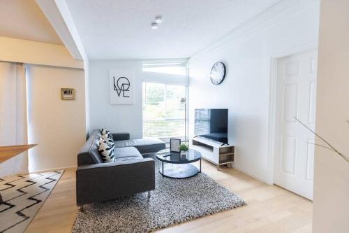a living room with a couch and a table at Beautiful Vancouver Special Home in Vancouver