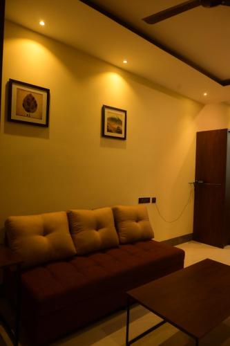 a living room with a couch and a table at La grande suite karaikal in kāraikāl