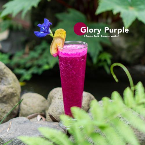 a pink drink with a banana and a blue flower at Aranka Tempasan in Sangyang