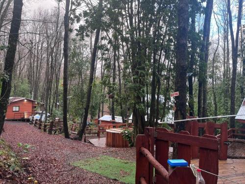 a wooden fence in the middle of a forest at Cabañas El Mirador de Recinto in Recinto