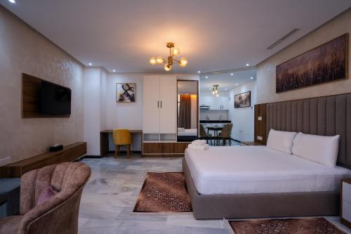a bedroom with a bed and a living room at IMMOKA SUITEs in Tangier
