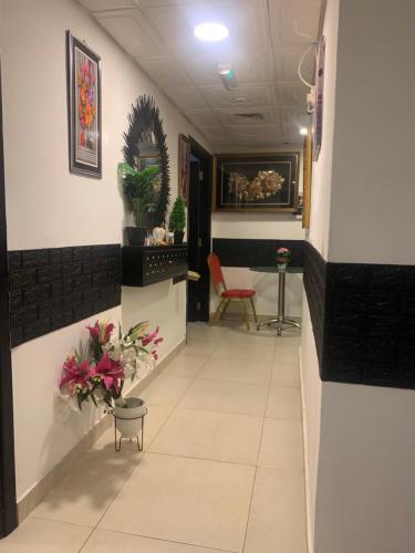 a hallway with a waiting room with flowers and plants at Frank spaces in Abu Dhabi