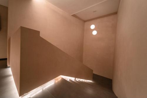 a staircase in a room with lights on the wall at 云漫山居民宿 in Xinglong