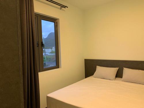 a bedroom with a bed and a window at LuxNar FF Sea in La Gaulette
