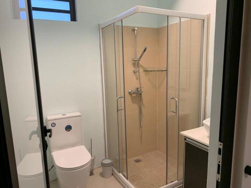 a bathroom with a glass shower with a toilet at LuxNar FF Sea in La Gaulette