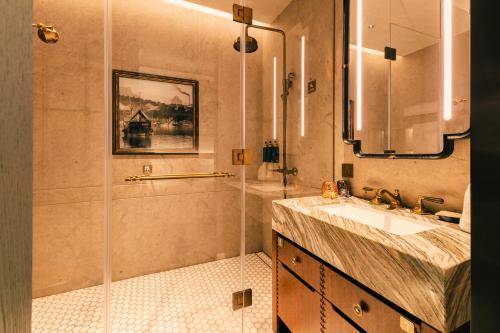 a bathroom with a shower and a sink at Hotel Central 新中央酒店 in Macau