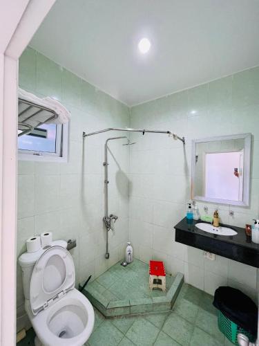 a bathroom with a shower and a toilet and a sink at VINBATH Check in in Nha Trang