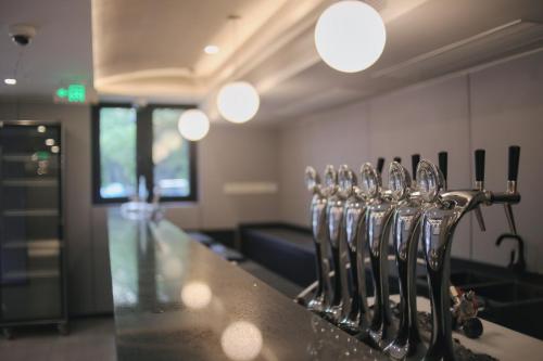 a group of silver utensils are lined up on a counter at Dayin Youth Hostel - Old Town & People's Square& Rail Hub -Social Area -Bar -Café -Gym -Free Laundry Luggage Storage -24H Front Desk -English Service in Shanghai