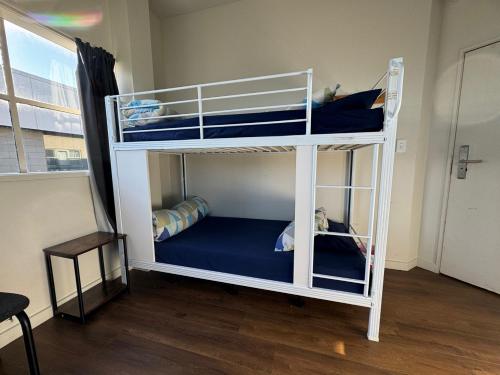 a couple of bunk beds in a room at Backpackers Central Hamilton in Hamilton