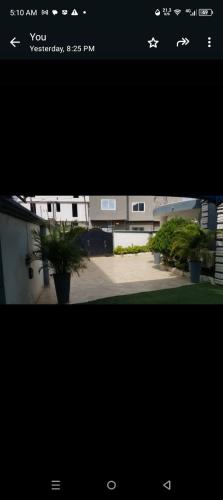 a screenshot of a picture of a building with plants at TeamVilla in Accra