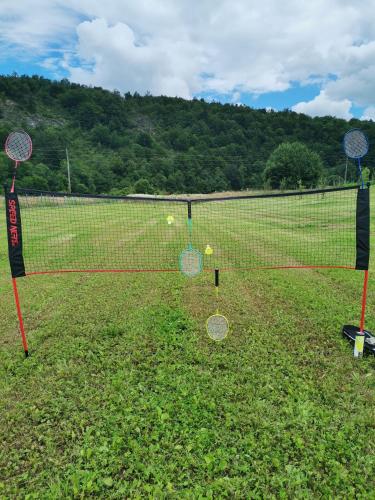 a tennis court with tennis rackets on the grass at Zeleni raj in Hreljin Ogulinski
