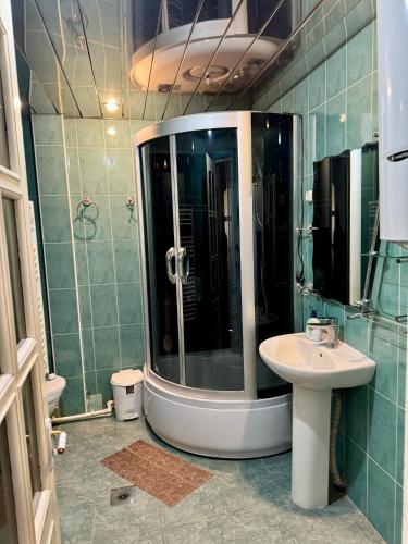 a bathroom with a shower and a sink at Guesthouses Opera in Yerevan
