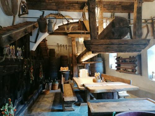 a dining room with wooden tables in a building at Hofer Hof in Feldthurns
