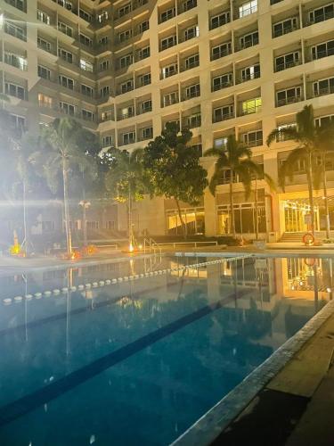 a swimming pool in front of a large building at SMDC Grace Residences in Manila