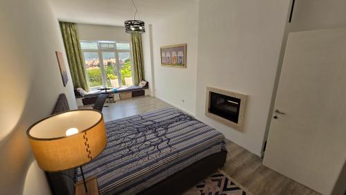a small bedroom with a bed and a fireplace at Village Gals in Đenovići