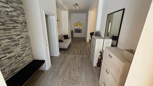 a hallway of a living room with a couch and a mirror at Village Gals in Đenovići