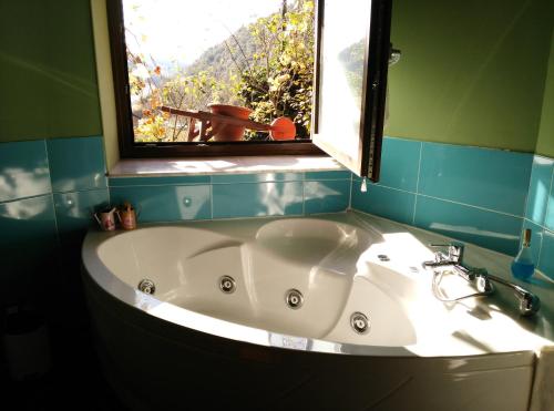 a bath tub in a bathroom with a window at Masia d'en Valentí in Anserall