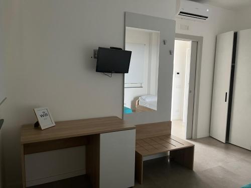 a room with a mirror and a desk with a tv at Miravesuvio in Pimonte