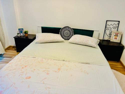 a bed with two pillows on it in a bedroom at Ultracentral Palas in Iaşi