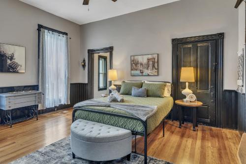 a bedroom with a bed and a table with a stool at Ross & Ashley's Retreat (117 Marion St, #1) in Clarksville