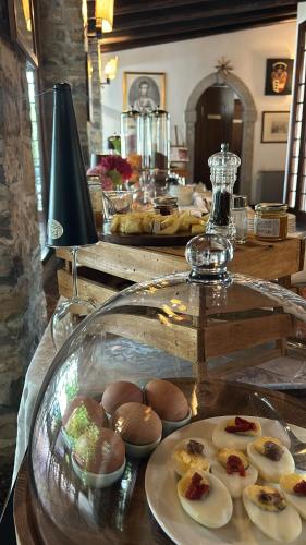 a buffet with a plate of food on a table at Hotel Conti Formentini in San Floriano del Cóllio