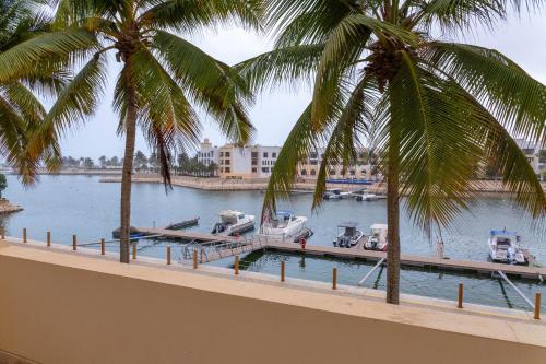 a view of a marina with boats in the water at Two Bedroom Apartment - Hawana Salalah in Ţāqah