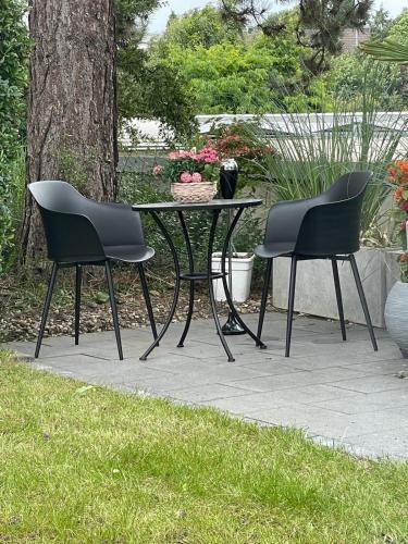 two chairs and a table in a garden at Dream Place in Iserlohn in Iserlohn